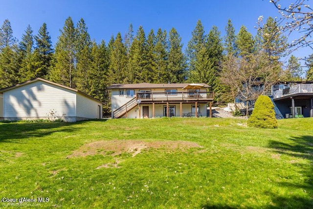 9218 W Rockford Bay Rd, Coeur Dalene, ID 83814 - rear view of property with a wooden deck, stairs, and a lawn