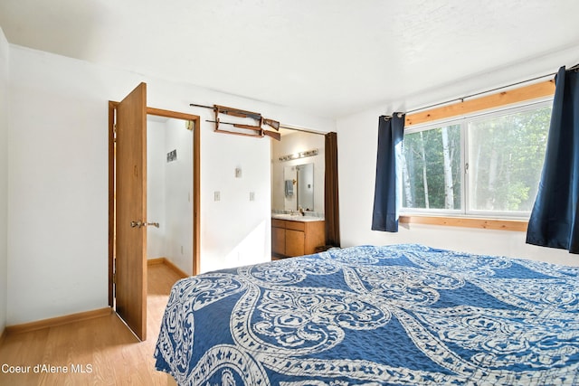 1655 Gun Club Rd, Sagle, ID 83860 - bedroom featuring light wood finished floors and connected bathroom