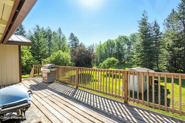 1655 Gun Club Rd, Sagle, ID 83860 - deck featuring a storage unit, a lawn, and a grill