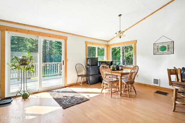 1655 Gun Club Rd, Sagle, ID 83860 - dining area with wood finished floors, lofted ceiling, a chandelier, and heating unit