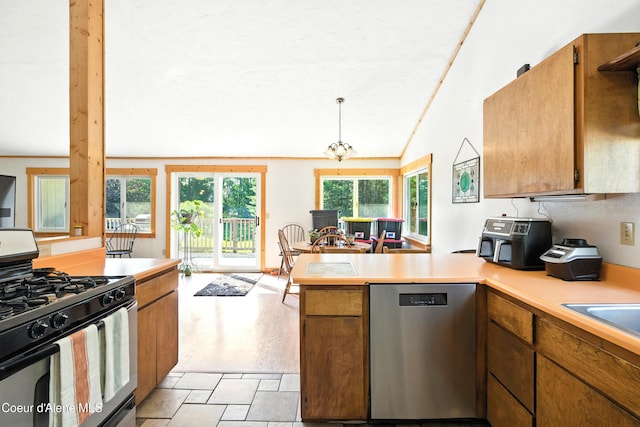 1655 Gun Club Rd, Sagle, ID 83860 - kitchen featuring range with gas cooktop, dishwasher, a peninsula, light countertops, and lofted ceiling