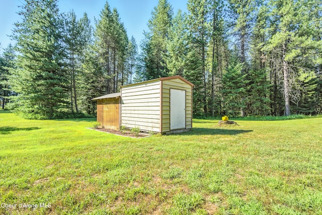 1655 Gun Club Rd, Sagle, ID 83860 - view of grassy yard featuring a storage unit and a view of trees