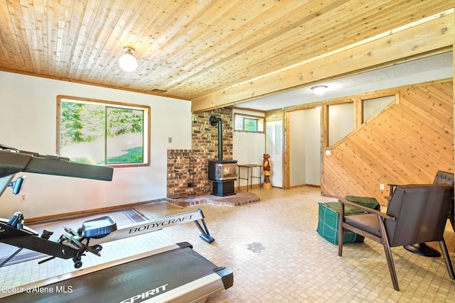 1655 Gun Club Rd, Sagle, ID 83860 - workout area featuring plenty of natural light, a wood stove, wood walls, and wooden ceiling