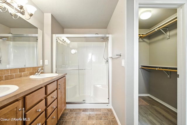1254 E Bogie Dr, Post Falls, ID 83854 - bathroom with a shower stall, a spacious closet, and double vanity
