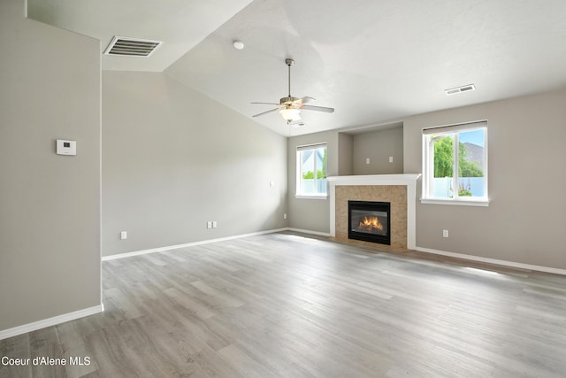 1254 E Bogie Dr, Post Falls, ID 83854 - unfurnished living room with ceiling fan, lofted ceiling, wood finished floors, and a fireplace