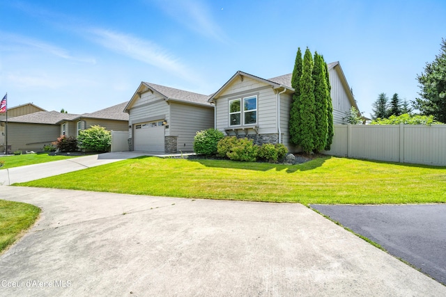 1254 E Bogie Dr, Post Falls, ID 83854 - view of front of home featuring stone siding, a garage, driveway, and a shingled roof