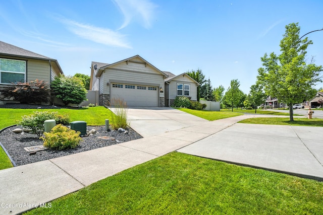 1254 E Bogie Dr, Post Falls, ID 83854 - view of front of home with concrete driveway, an attached garage, and stone siding