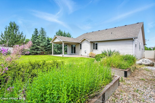 1254 E Bogie Dr, Post Falls, ID 83854 - back of property with a patio area, a garden, and a shingled roof
