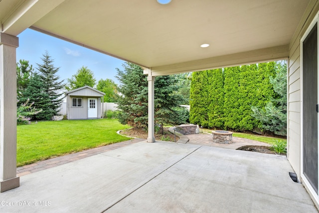 1254 E Bogie Dr, Post Falls, ID 83854 - view of patio / terrace featuring a fire pit and an outbuilding