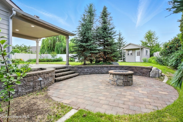 1254 E Bogie Dr, Post Falls, ID 83854 - view of patio / terrace featuring a fire pit and an outdoor structure