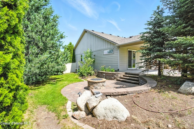 1254 E Bogie Dr, Post Falls, ID 83854 - view of grassy yard with an outdoor fire pit and a patio