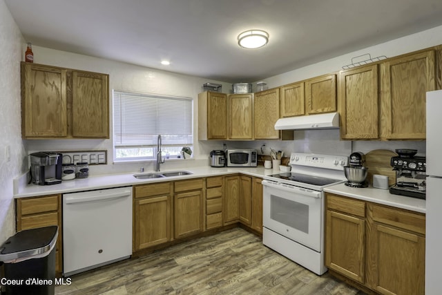 517 N Stephen St, Clark Fork, ID 83811 - kitchen featuring white appliances, under cabinet range hood, wood finished floors, light countertops, and brown cabinets