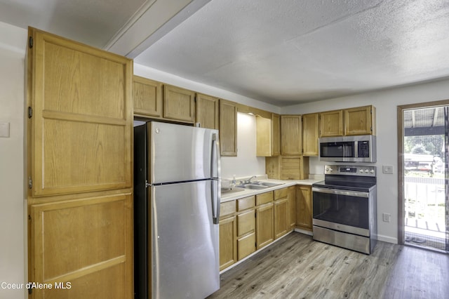 517 N Stephen St, Clark Fork, ID 83811 - kitchen featuring stainless steel appliances, light wood-style floors, light countertops, and a textured ceiling