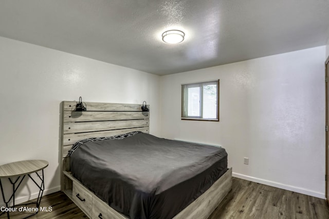 517 N Stephen St, Clark Fork, ID 83811 - bedroom with dark wood-type flooring and a textured ceiling