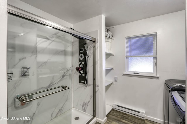 517 N Stephen St, Clark Fork, ID 83811 - bathroom featuring baseboard heating, separate washer and dryer, a marble finish shower, and wood finished floors