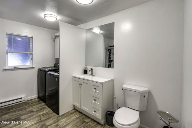 517 N Stephen St, Clark Fork, ID 83811 - full bathroom with washer and dryer, a baseboard heating unit, wood finished floors, and vanity