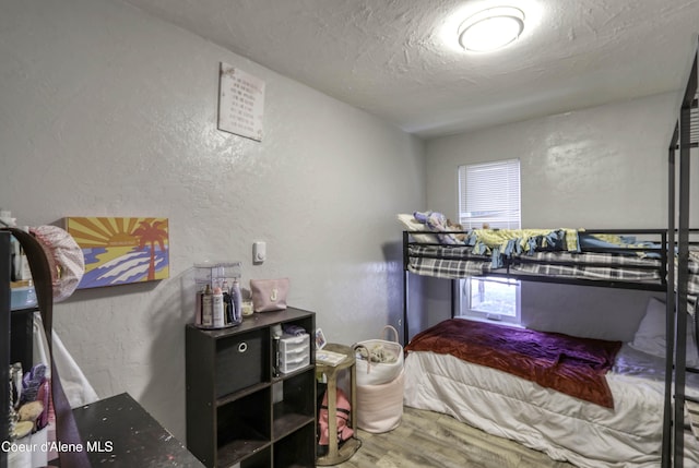 517 N Stephen St, Clark Fork, ID 83811 - bedroom with a textured wall, wood finished floors, and a textured ceiling
