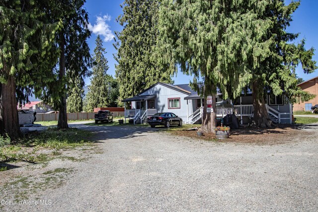 517 N Stephen St, Clark Fork, ID 83811 - view of front facade featuring gravel driveway and covered porch