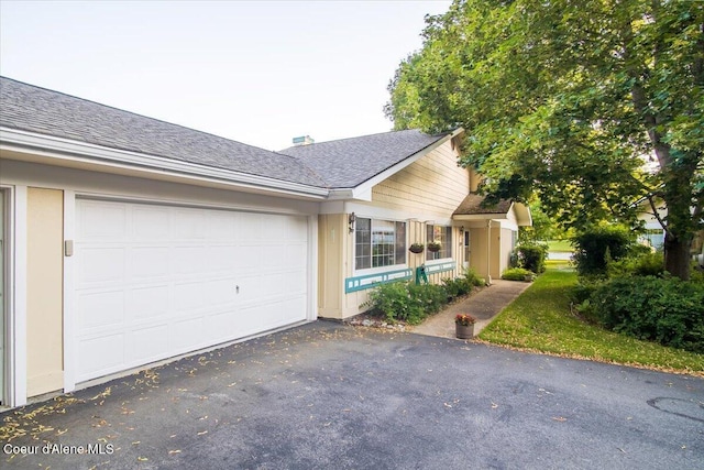 4922 W Village Blvd # 5, Rathdrum, ID 83858 - view of front facade featuring asphalt driveway, a garage, and roof with shingles