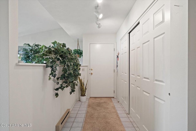 4922 W Village Blvd # 5, Rathdrum, ID 83858 - entryway featuring a baseboard heating unit, light tile patterned flooring, and track lighting