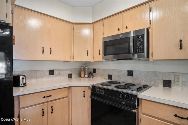 4922 W Village Blvd # 5, Rathdrum, ID 83858 - kitchen featuring stainless steel microwave, electric range, light brown cabinetry, light countertops, and tasteful backsplash