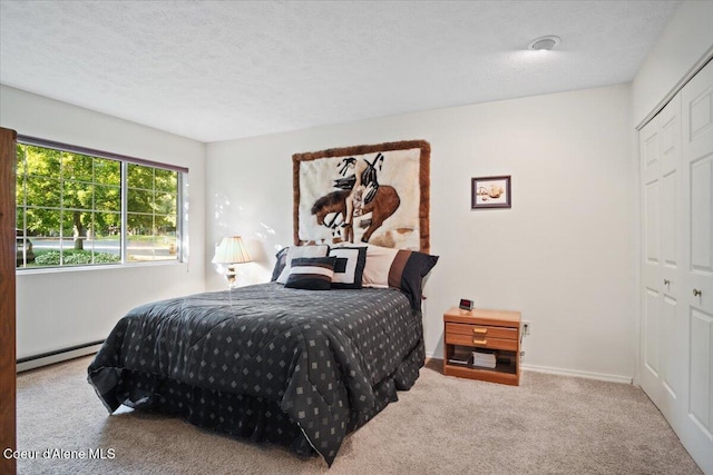4922 W Village Blvd # 5, Rathdrum, ID 83858 - carpeted bedroom featuring a baseboard heating unit and a textured ceiling