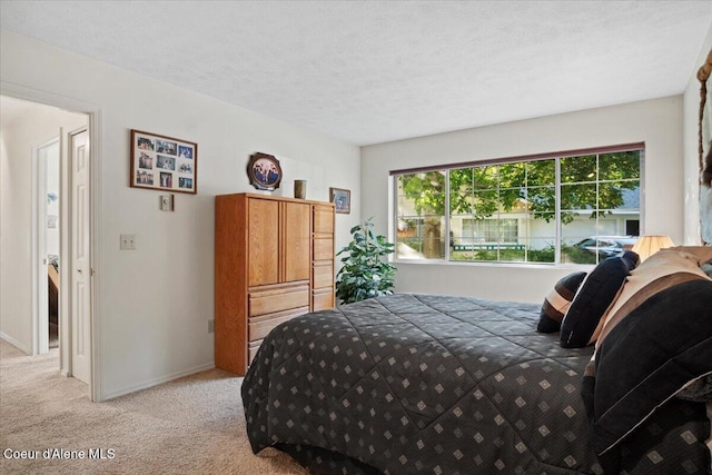 4922 W Village Blvd # 5, Rathdrum, ID 83858 - bedroom with light colored carpet and a textured ceiling