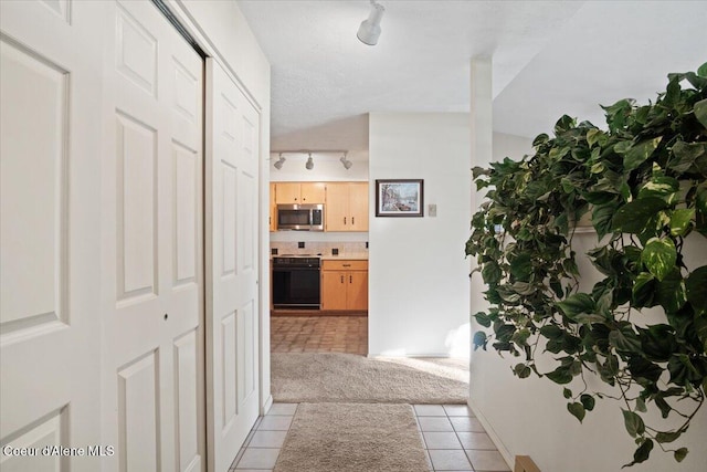 4922 W Village Blvd # 5, Rathdrum, ID 83858 - corridor featuring rail lighting and light tile patterned floors