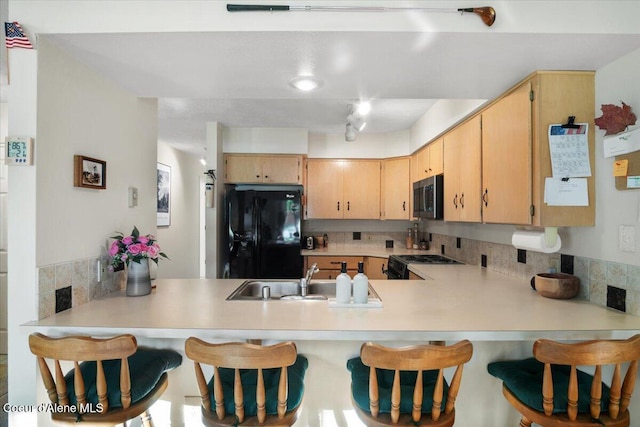 4922 W Village Blvd # 5, Rathdrum, ID 83858 - kitchen featuring black appliances, a peninsula, and backsplash