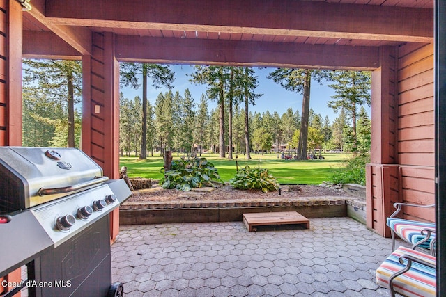 5299 W Green Ct # 23, Rathdrum, ID 83858 - view of patio / terrace with grilling area and view of scattered trees