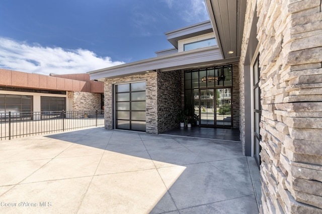 1758 W Bellerive Ln, Coeur Dalene, ID 83814 - property entrance featuring stone siding and an attached garage