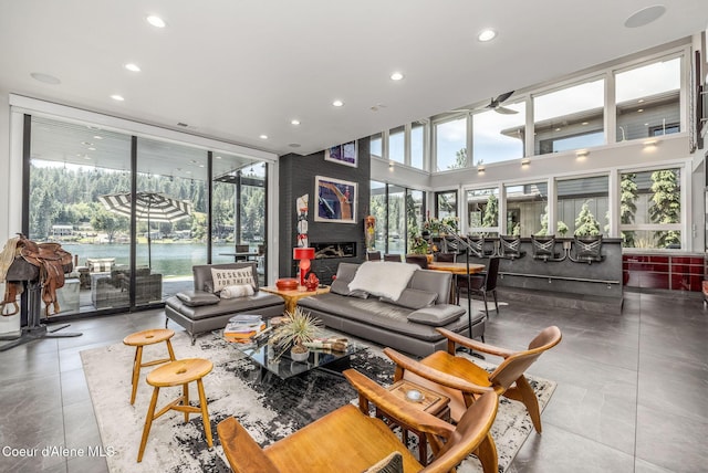 1758 W Bellerive Ln, Coeur Dalene, ID 83814 - living room featuring plenty of natural light, a ceiling fan, recessed lighting, and a towering ceiling