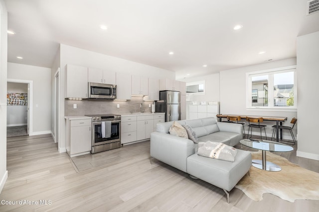 1758 W Bellerive Ln, Coeur Dalene, ID 83814 - living room with light wood-style floors and recessed lighting