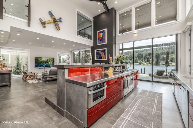 1758 W Bellerive Ln, Coeur Dalene, ID 83814 - kitchen featuring double oven range, a high ceiling, healthy amount of natural light, modern cabinets, and open floor plan