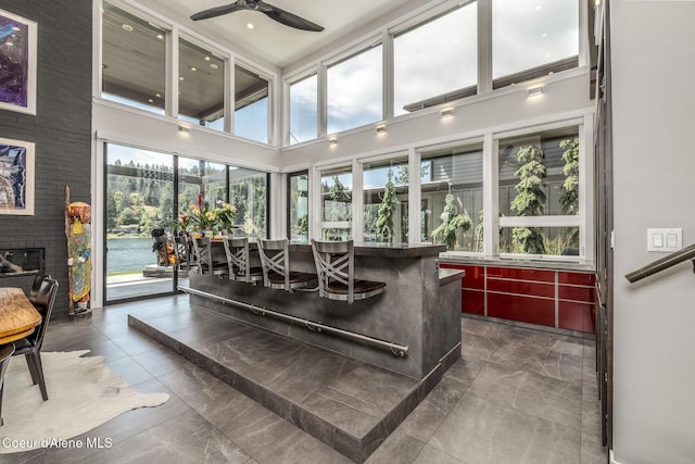 1758 W Bellerive Ln, Coeur Dalene, ID 83814 - living room featuring ceiling fan, marble finish floors, a high ceiling, a fireplace, and recessed lighting