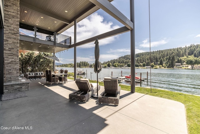 1758 W Bellerive Ln, Coeur Dalene, ID 83814 - patio / terrace with a water view, a boat dock, a patio, and a forest view