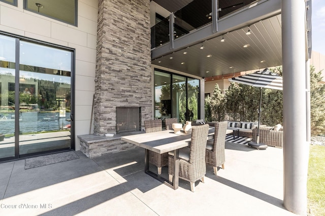 1758 W Bellerive Ln, Coeur Dalene, ID 83814 - view of patio featuring an outdoor living space with a fireplace and outdoor dining area