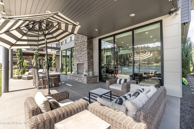 1758 W Bellerive Ln, Coeur Dalene, ID 83814 - view of patio with an outdoor living space with a fireplace and outdoor dining space