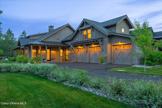 428 W Beach Ct, Dover, ID 83825 - view of front of house featuring a front lawn, a chimney, asphalt driveway, and board and batten siding
