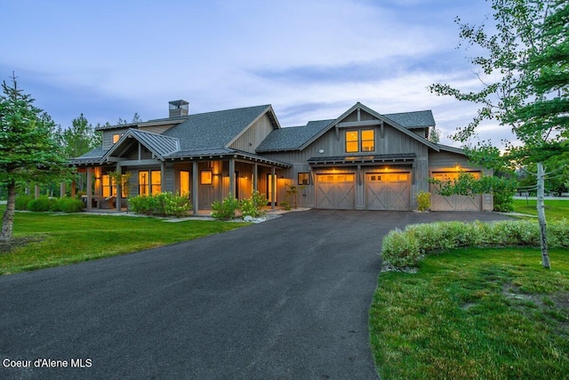 428 W Beach Ct, Dover, ID 83825 - modern inspired farmhouse featuring a chimney, driveway, a front lawn, a standing seam roof, and a garage