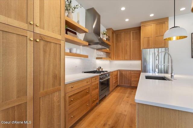 428 W Beach Ct, Dover, ID 83825 - kitchen featuring wall chimney exhaust hood, appliances with stainless steel finishes, open shelves, light wood-style floors, and light countertops