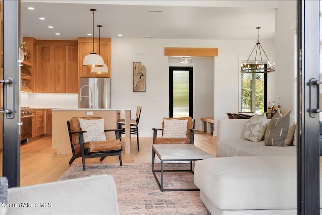 428 W Beach Ct, Dover, ID 83825 - living room featuring a chandelier, light wood finished floors, and recessed lighting