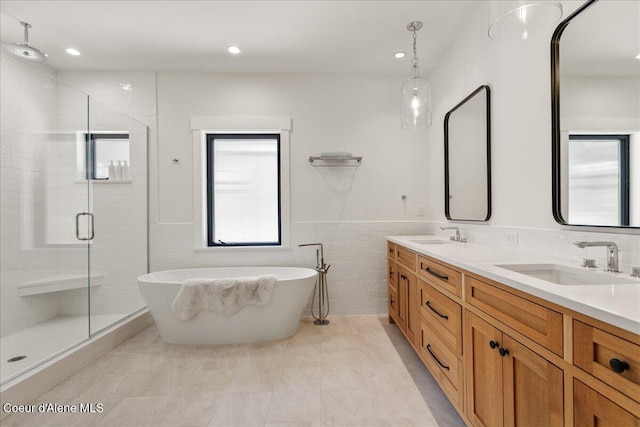 428 W Beach Ct, Dover, ID 83825 - bathroom with a shower stall, double vanity, a freestanding bath, recessed lighting, and tile walls