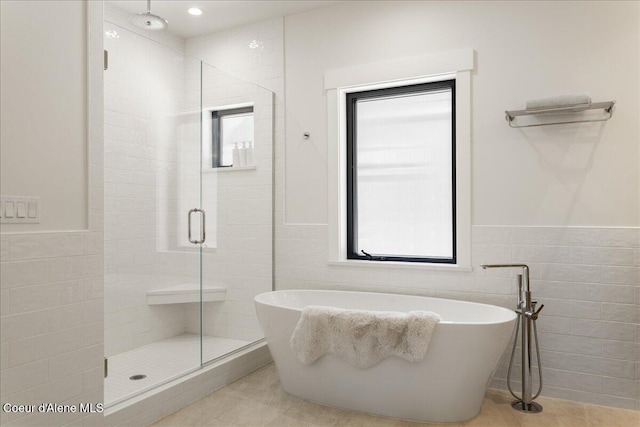 428 W Beach Ct, Dover, ID 83825 - full bath with a shower stall, tile walls, a soaking tub, tile patterned floors, and a wainscoted wall