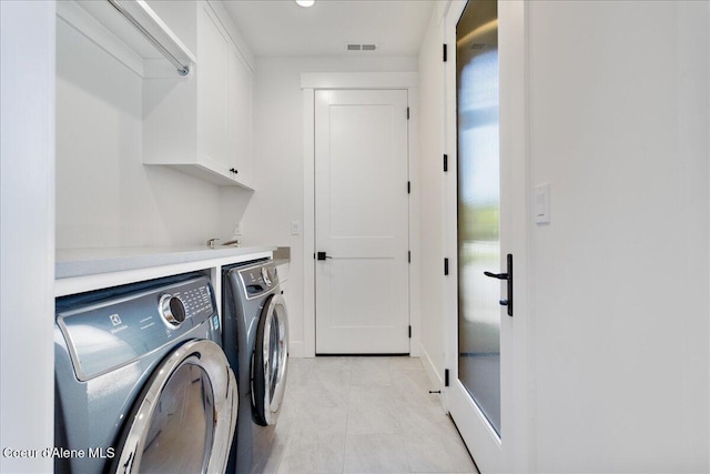 428 W Beach Ct, Dover, ID 83825 - laundry room with washer and dryer, cabinet space, and light tile patterned floors