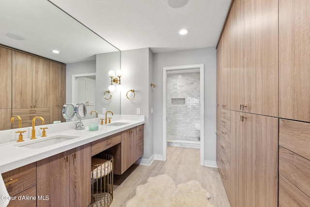 4732 S Arrow Point Dr # 304, Harrison, ID 83833 - full bath featuring double vanity, wood finished floors, a shower stall, and recessed lighting