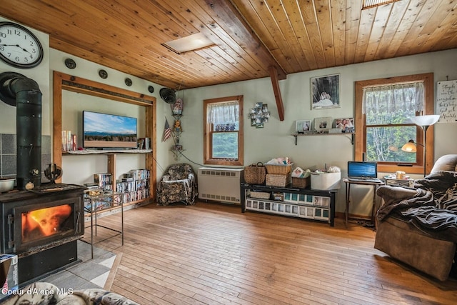 854 Two Tail Rd, Bonners Ferry, ID 83805 - living room featuring a wood stove, wood ceiling, wood-type flooring, and radiator heating unit