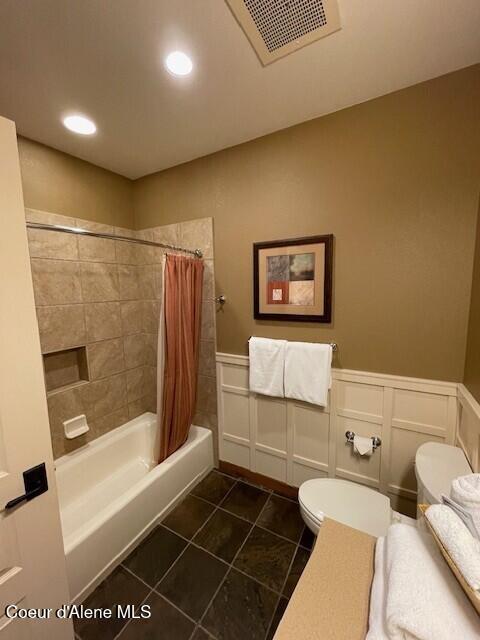 150 Morning Star Dr Unit 379, Kellogg, ID 83837 - bathroom featuring a decorative wall, shower / tub combo, tile patterned flooring, wainscoting, and recessed lighting