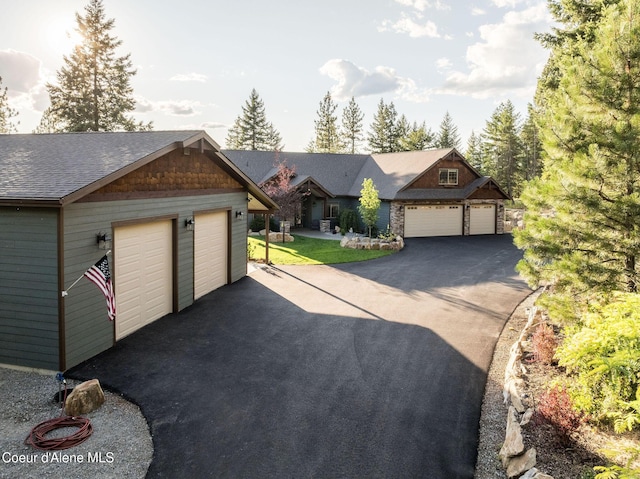 16749 W Cade Rd, Hauser, ID 83854 - view of front facade with an outbuilding, asphalt driveway, and a shingled roof
