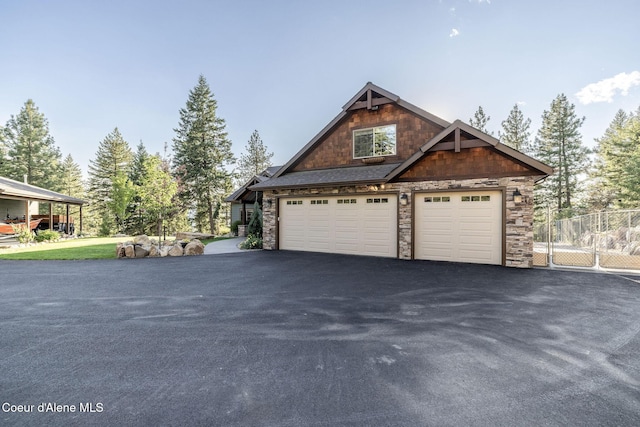 16749 W Cade Rd, Hauser, ID 83854 - view of front of property with stone siding and a garage